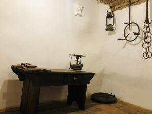 a room with a wooden table with a lamp on it at Ca' del Borgo in Venosa