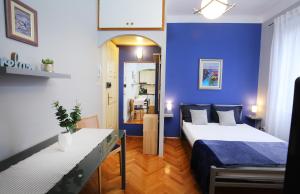 Zimmer mit einem Bett und einer blauen Wand in der Unterkunft SPLIT CHIC Studio in Split