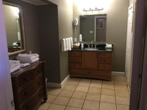 a bathroom with a sink and a large mirror at Island House Historic Vacation Rentals in Port Clinton