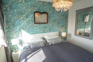 1 dormitorio con 1 cama con papel pintado de flores azul en Villa Golding - Flat 3, en Dresden