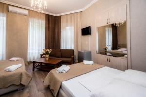 een hotelkamer met 2 bedden en een woonkamer bij Star Hotel in Tbilisi City