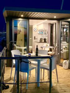 a dining table and chairs on a balcony at Houseboat Seabreeze in Alghero