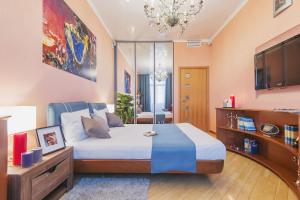a bedroom with a large bed and a tv at GMApartments Tverskaya, 15 in Moscow