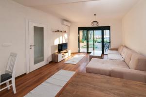 a living room with a couch and a table at Dunja Boka Bay in Herceg-Novi