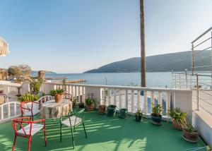 a balcony with a table and chairs and the water at Dunja Boka Bay in Herceg-Novi