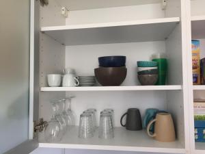 a kitchen pantry filled with dishes and glassware at LOT OF BED in Cahors