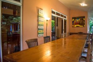 a large wooden table in a room with chairs at Fare Om in Pihaena