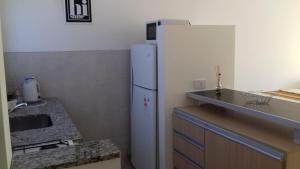 a kitchen with a white refrigerator and a counter at Terrazas de la Colina 1.1 in Victoria