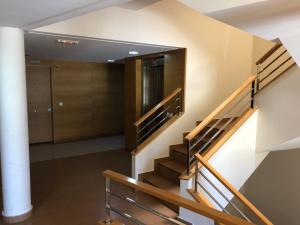 a staircase in a building with a hallway and a door at Vista Roja in El Médano