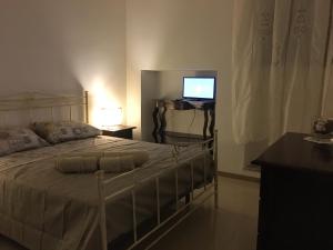 Postel nebo postele na pokoji v ubytování B&B Domus Gaetani