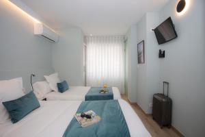 Postel nebo postele na pokoji v ubytování Palacios Rooms