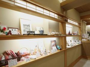 a display case in a store filled with toys at Shibu Onsen KOKUYA in Yamanouchi