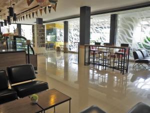 a lobby with chairs and tables in a building at d'primahotel ITC Mangga Dua in Jakarta