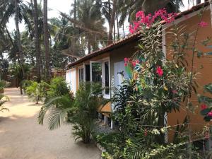 a house with flowers on the side of it at Art Resort Goa in Palolem