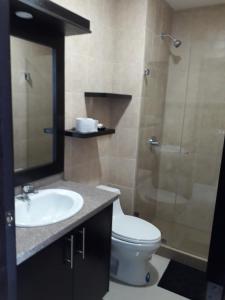 a bathroom with a toilet and a sink and a shower at FONTAINE BLEAU in Tonsupa