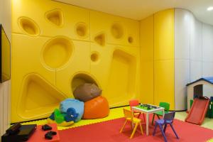 a small child is sitting in a toy room at Novotel Bangkok Sukhumvit 20 - SHA Extra Plus Certified in Bangkok