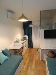 a room with two beds and a kitchen with a table at City Center Apartment 2 in Tbilisi City