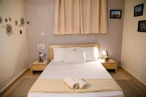 um quarto com uma cama com duas toalhas em אצלנו - בגליל העליון em Quriate-Chemoná