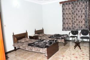 Postel nebo postele na pokoji v ubytování Tulip Guest House Abbottabad + 4 fotografie