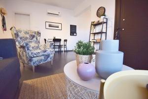 a living room with a chair and a table at Limegrove Holiday Apartment in Protaras