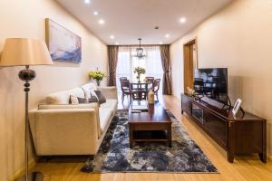 a living room with a couch and a table at Green Court Residence Jinqiao Diamond Shanghai in Shanghai