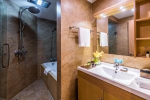 a bathroom with a sink and a shower at Green Court Residence Jinqiao Diamond Shanghai in Shanghai