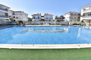 a large swimming pool in front of some apartment buildings at Limegrove Holiday Apartment in Protaras
