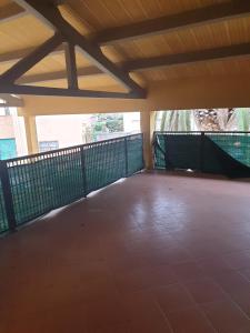 an empty room with a balcony with two windows at Condominio Flabelli in Baratti