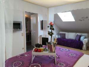 a living room with a purple table and a purple couch at WohlFühlPlatz´l in Stegersbach