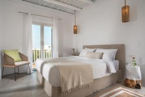 A bed or beds in a room at Delmar Apartments & Suites Milos - Delmar Collection