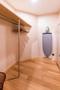 a room with a tv on a wall with a wooden floor at Green Court Residence Jinqiao Diamond Shanghai in Shanghai