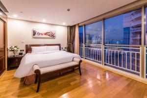 a bedroom with a bed and a large window at Green Court Residence Jinqiao Diamond Shanghai in Shanghai