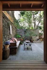 a patio with a couch and a table and a stone wall at Hidden Garden Suites in Istanbul