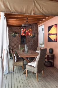 a wooden table with chairs and a chandelier at Hidden Garden Suites in Istanbul