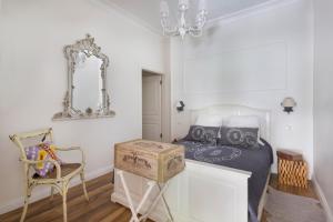 a bedroom with a bed and a chair and a mirror at Hidden Garden Suites in Istanbul