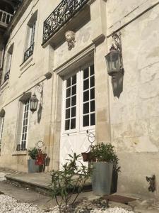 un edificio con una puerta blanca y una ventana en Le Grand Vaudon en Rochecorbon