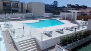 a swimming pool on the roof of a house at Americas Heart ! in Arona