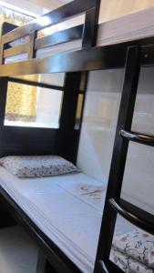 a bunk bed with a pillow on the bottom bunk at Traveller's Hostel in Hong Kong
