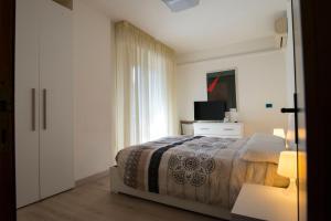 a bedroom with a bed and a television at B&B il Bacio in Perugia