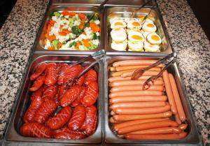 a tray of food with carrots and other foods at Hotel Toč in Lipova Lazne