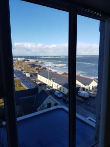 a view of the ocean from a window at Atlantic views top floor in Portrush