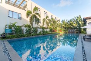 a swimming pool in front of a building at Iccssi Villa Haitang Bay Sanya in Sanya