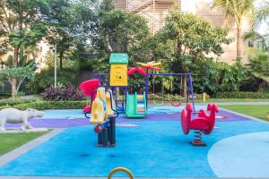 a playground in a park with slides and swings at Iccssi Villa Haitang Bay Sanya in Sanya