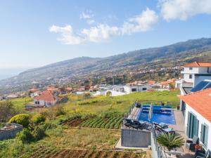 a view from a house with a swimming pool at Casa Lira in Arco da Calheta