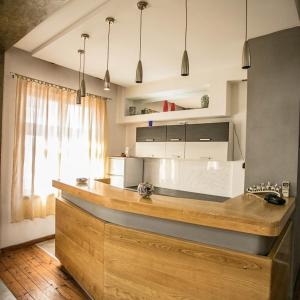 a kitchen with a large island in a room at Apartmani DiO in Niš