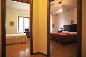 a mirror in a room with a bed and a bedroom at albergo Fiorentino in Sansepolcro