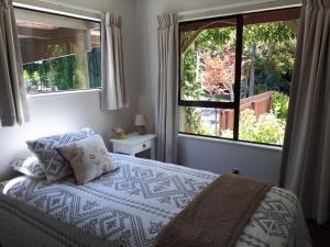 a bedroom with a bed and a large window at Rangaroa Heights in Taumarunui