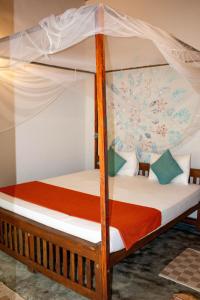 a bedroom with a bunk bed with a canopy at Mellow Hostel Sri Lanka in Ahangama