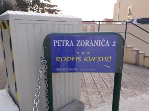 a blue sign is chained to a fence at Rooms Kvestic in Dubrovnik