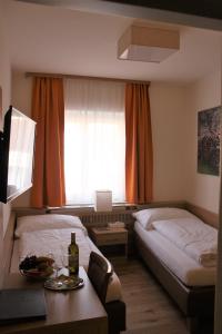 A bed or beds in a room at Weinhotel Rieder